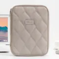Detailed view of the quilted 11-inch tablet sleeve in a minimalist office desk setting - Gray