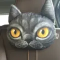 Realistic 3D printed cat head car headrest pillow shown on a brown leather car seat - Black Shorthair Cat / 30cm*22cm