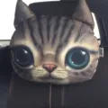 Close-up of a 3D printed cat face car neck pillow featuring large blue eyes and realistic fur - Cute Cat
