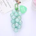Close-up detail of a mint green iridescent grape bead keychain with a heart tag. - Green Grape Cluster