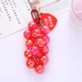 Close-up of a vibrant pink grape-shaped beaded keychain featuring a red heart tag - Red Grape Cluster