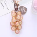 Macro view of colorful iridescent grape-shaped round bead keychain pendant - Brown Grape String