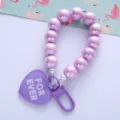Detail view of the iridescent purple UV plated beads and heart pendant keychain - Purple
