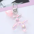 Close-up of pink iridescent balloon dog keychain featuring a cute heart charm detail - Pink