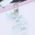 Detailed close-up of an iridescent balloon dog keychain with a matching heart charm - Blue