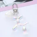 Macro view of iridescent balloon dog keychain with a pearlescent heart charm. - White