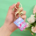 Close-up of mini cube keychain featuring cute pink cartoon rabbit and Nice Day text - Rose Red
