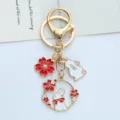 Exquisite metal rabbit and cherry blossom keychain with red bow and enamel detail - Red Bowtie Rabbit - Lobster Clasp
