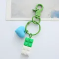 Detail of green brick keychain featuring a blue 3D heart charm on a clean white surface - Single OPP Bag Packaging / Green building block love buckle