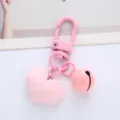 Detail view of a cute pink faceted heart keychain with a matching bell charm - Single Piece / Pink