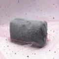 Detailed view of soft grey plush octagonal pencil case with cute pink ribbon decoration - Gray