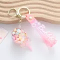 Detailed view of a cute pink lollipop liquid shaker keychain with colorful candy beads inside - Oil-Filled Lollipop / Pink