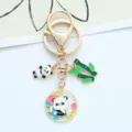 Detailed view of cute panda and bamboo charms on a gold-tone creative keychain - Hugging Panda