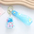 Close-up detail of a light blue unicorn keychain featuring colorful oil floating beads. - Unicorn / Blue