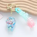 Detailed view of acrylic astronaut liquid quicksand keychain with colorful beads - Blue Liquid Astronaut Style