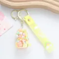 Detailed close-up of a creative yellow unicorn liquid oil keychain with wish strap - Yellow Liquid Unicorn Style
