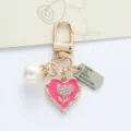 Detailed view of pink heart keychain with rhinestone flower, pearl and id tag charm - Rose Red