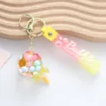 Detail of cute lollipop quicksand keychain with pink and yellow gradient strap - Oil-Filled Lollipop / Yellow