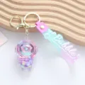 Close-up of cute acrylic oil-filled astronaut keychain with liquid quicksand effect - Purple Liquid Astronaut Style