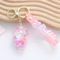 Detailed close-up of a pink acrylic liquid sand astronaut keychain with Bubble strap - Pink Liquid Astronaut Style