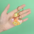 Detailed view of heart liquid keychain with shells and yellow glitter sand - Heart Yellow