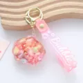 Close-up of creative pink seashell oil-filled quicksand keychain with star details - Liquid Shell / Pink