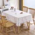 White lace tablecloth detail showcasing delicate leaf patterns and elegant ruffled edges. - 130*180cm / Leaf White