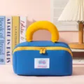 Portable blue and yellow pillow-handle cosmetic bag for travel toiletry storage - Blue (Pillow)
