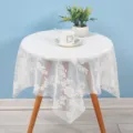 Detailed view of white lace tablecloth showing hollow floral pattern and delicate fabric texture. - 60*60cm / Elegant White