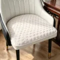 Vue détaillée du coussin de chaise en fer à cheval unicolore avec un motif à pois élégant. - Beige
