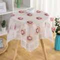 Close-up detail of white lace hollow embroidered tablecloth, showing exquisite floral pattern. - Rose Florals - White