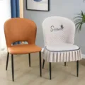 Detailed view of luxury dining chair cover with quilted pattern, sweethearts embroidery and ruffles. - Chair Cover / Beige