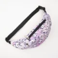 Detail view of a purple unicorn print fanny pack with adjustable black waist strap. - Pink Unicorn