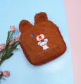 Detail view of the embroidered bear character on the brown teddy fleece pouch - Coffee Bear