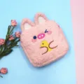 Close-up of pink fluffy cosmetic pouch with cute embroidered animal design - Pink Pig