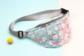 Detail view of waterproof transparent PVC waist bag with cute pink flamingo print design - Black Polka Dot Flamingo