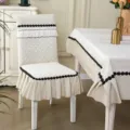 Quilted cream white dining chair cover variant with elegant black trim and ruffle details. - Snowflake Beige