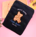 Close-up of cute plush laptop sleeve with bear embroidery, featuring soft velvet texture - Owo Bear / Black