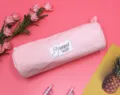 Detail view of a cute pink corduroy pencil case stationery bag with alpaca LUCKY DAY patch - Pink