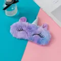 Detailed view of the soft purple plush unicorn sleep eye mask with silver horn - Violet