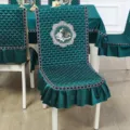 Detailed macro view of teal green quilted chair cover with embroidered swan motif design - Chair Cover / Integrated Swan Green