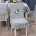 Close-up view of a grey quilted chair cover featuring cute panda embroidery and lace trim - Panda Gray