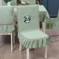 Close-up of quilted sage green chair cover with cute panda embroidery and lace trim - Panda Green
