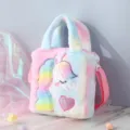 Close-up of soft rainbow plush unicorn handbag for girls with embroidered pink heart details - Colorful Powder