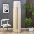 Close-up of a cream cylindrical air conditioner cover with elegant lace and pom-pom trim - Stay-on AC Cover - Candy Brown