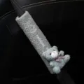 Detail view of plush gray car seatbelt cover with cute teddy bear and embroidery - Blue Bear