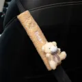 Detail of cute plush bear car seat belt cover with soft fleece texture and embroidered bear text - Yellow Bear