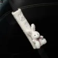 Close-up of white plush car seatbelt cover with cute rabbit doll and bow - White Rabbit