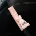 Close-up of pink plush rabbit car seat belt shoulder cover with soft fleece texture. - Pink Rabbit