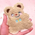 Close-up view of the curly plush material and fine embroidery on this cute bear card holder - Bear / Brown